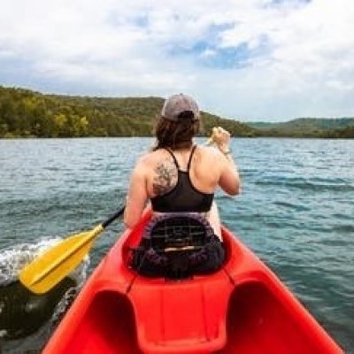 a person riding on the back of a boat in a body of water
