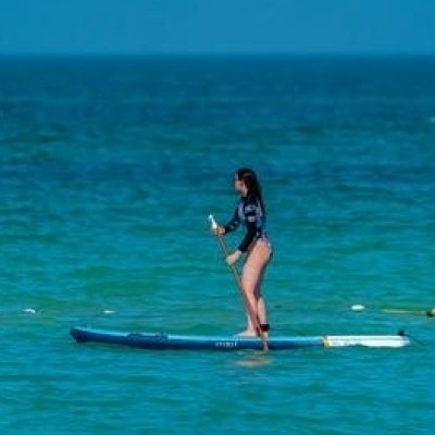 a girl riding a wave on a surfboard in the water